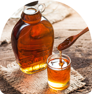 Maple syrup pouring into glass