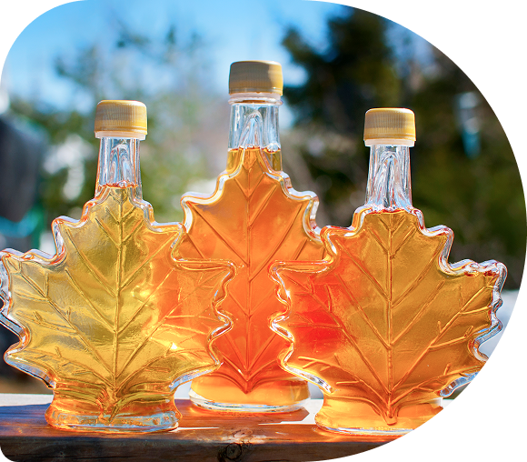 Three leaf-shaped maple syrup bottles