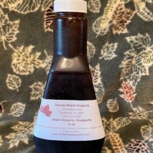 Vinaigrette bottle displayed against leafy background