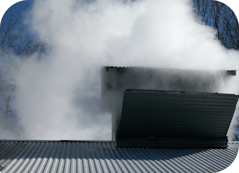 Corrugated metal roof with thick white smoke